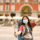 tourist in a mask taking a selfie